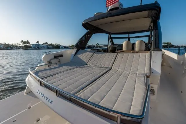  Yacht Photos Pics 2019 Absolute 40 SLT yacht with spacious sun deck, docked by serene waters.