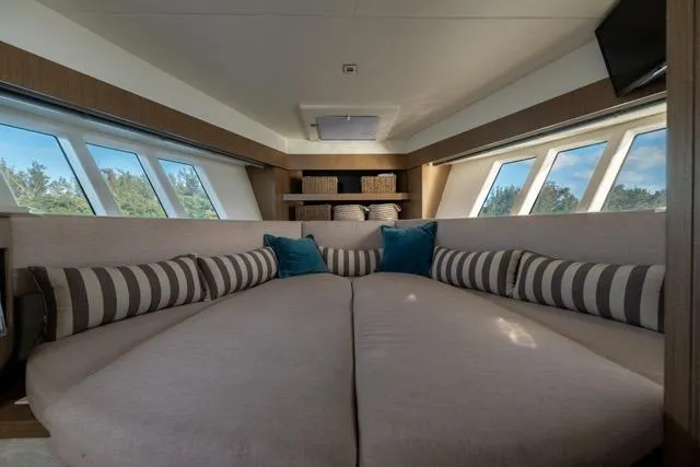  Yacht Photos Pics Luxurious interior of 2019 Absolute 40 SLT yacht with plush seating and striped cushions.