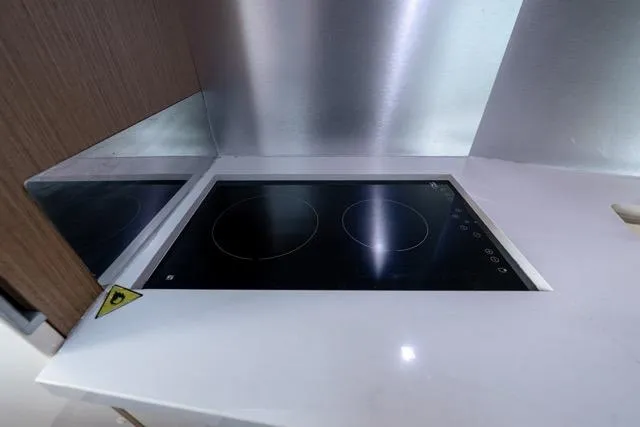  Yacht Photos Pics Modern kitchen with sleek induction cooktop on Absolute 40 SLT, 2019 model.