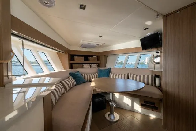  Yacht Photos Pics Luxurious interior of 2019 Absolute 40 SLT yacht with elegant seating and panoramic windows.