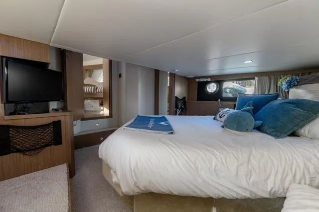  Yacht Photos Pics Luxurious bedroom interior of 2019 Absolute 40 SLT yacht with modern amenities.