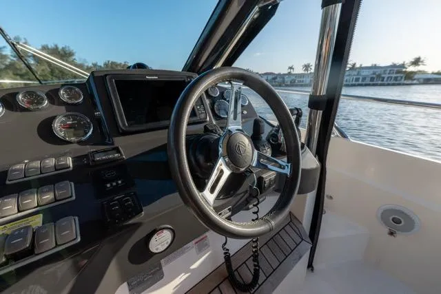  Yacht Photos Pics Cockpit view of 2019 Absolute 40 SLT yacht with steering wheel and control panel.