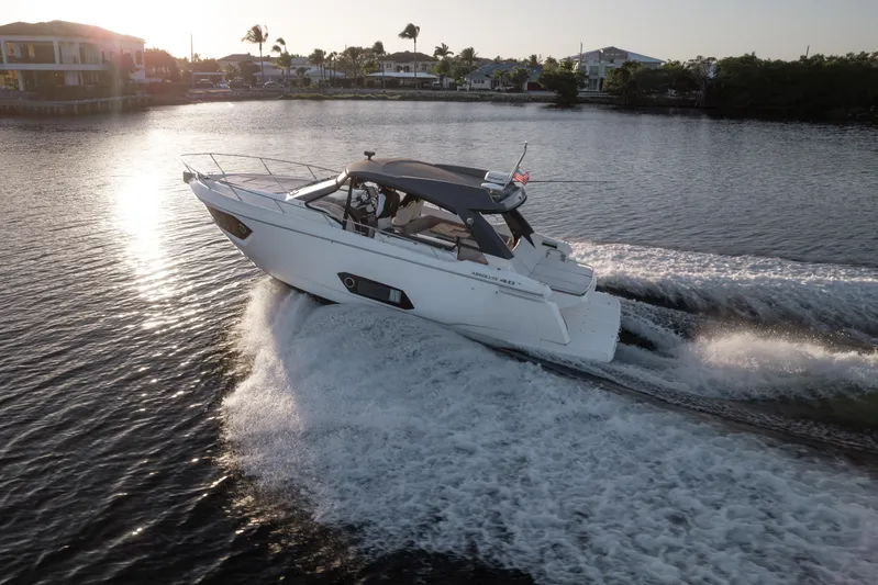  Yacht Photos Pics 2019 Absolute 40 SLT yacht cruising on a sunny day, creating waves in the water.