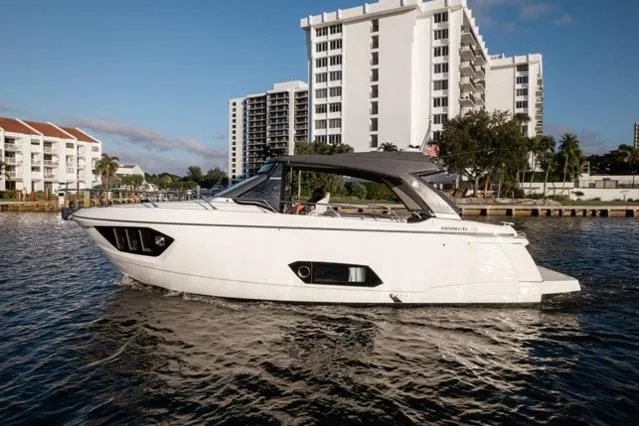  Yacht Photos Pics 2019 Absolute 40 SLT yacht cruising near waterfront buildings.