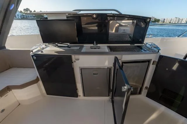  Yacht Photos Pics 2019 Absolute 40 SLT yacht kitchen with open cabinets and modern appliances.