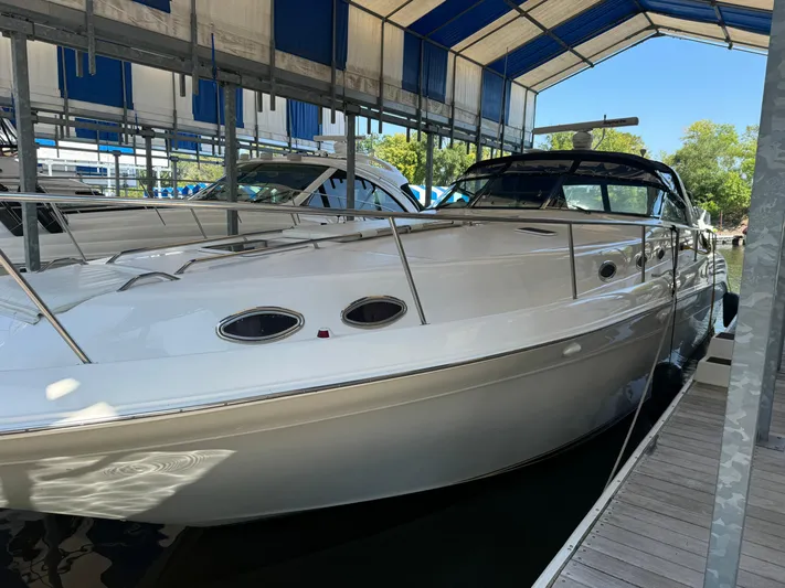 Salad Yacht Photos Pics 1997 Sea Ray 450 Sundancer docked under a blue canopy.