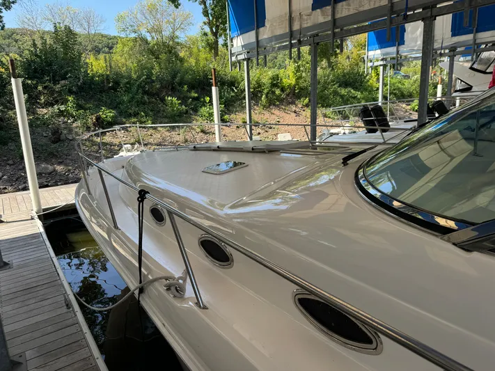 Salad Yacht Photos Pics 1997 Sea Ray 450 Sundancer docked, showcasing sleek design and spacious deck.