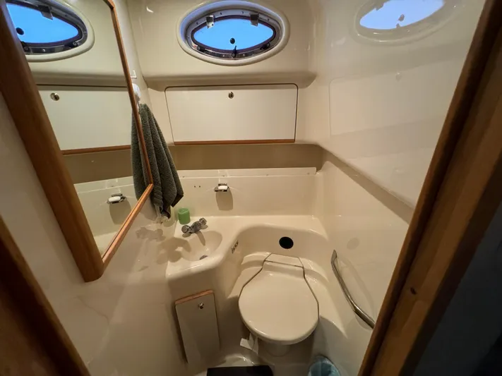 Salad Yacht Photos Pics Bathroom interior of 1997 Sea Ray 450 Sundancer yacht, featuring compact design and porthole window.