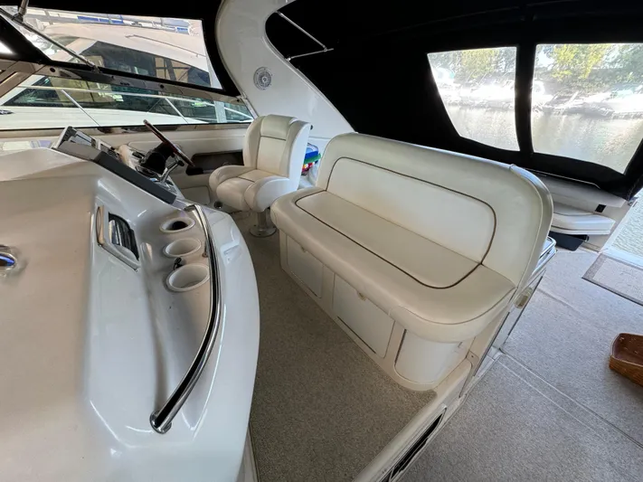 Salad Yacht Photos Pics 1997 Sea Ray 450 Sundancer interior with white seating and helm station.