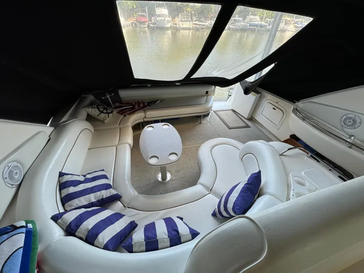 Salad Yacht Photos Pics Luxurious 1997 Sea Ray 450 Sundancer interior with striped cushions and a small table.