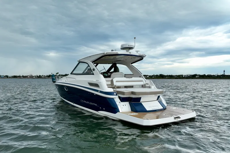 Motivated Yacht Photos Pics 2017 Regal 35 Sport Coupe boat on water under cloudy sky.