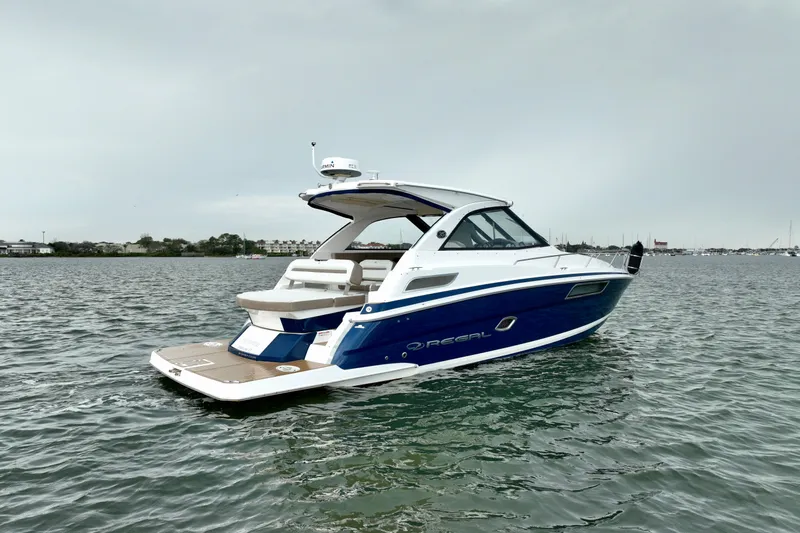 Motivated Yacht Photos Pics 2017 Regal 35 Sport Coupe boat on calm water, showcasing sleek design and luxury features.