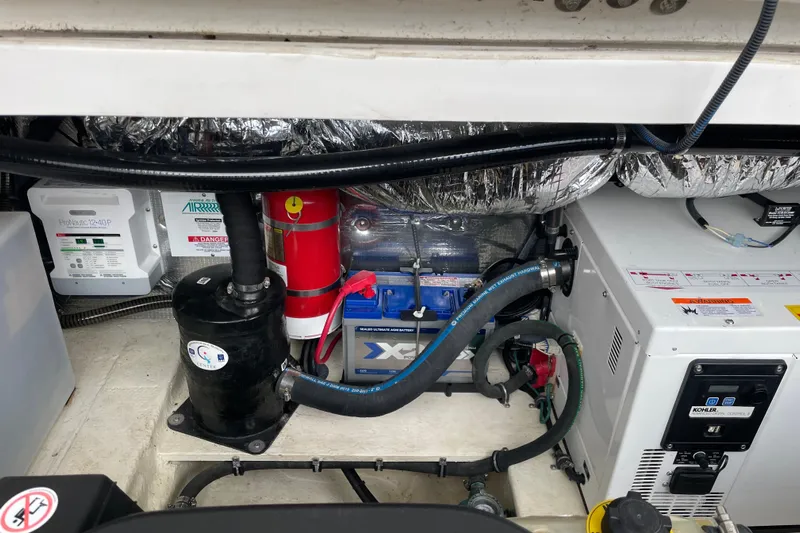 Motivated Yacht Photos Pics Engine compartment of a 2017 Regal 35 Sport Coupe with various components and wiring.