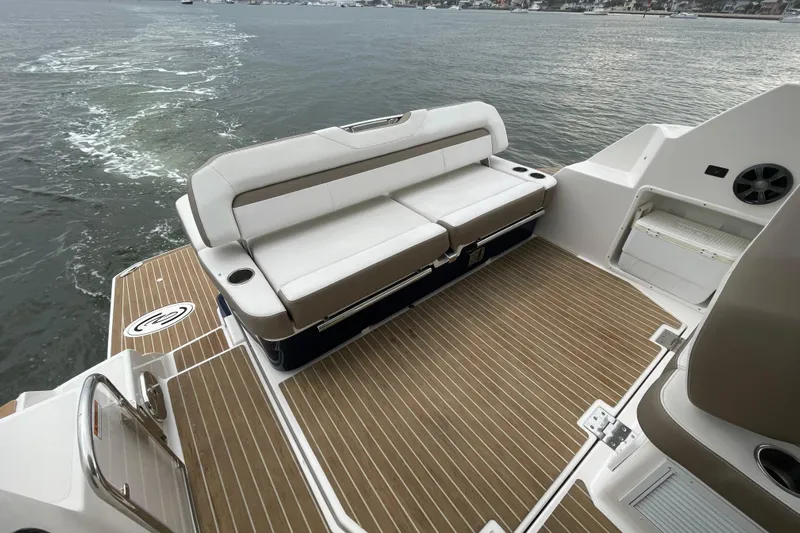 Motivated Yacht Photos Pics 2017 Regal 35 Sport Coupe boat deck with seating, overlooking calm waters.