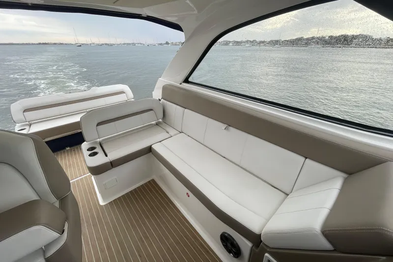 Motivated Yacht Photos Pics Luxurious interior of 2017 Regal 35 Sport Coupe yacht with comfortable seating and scenic water view.