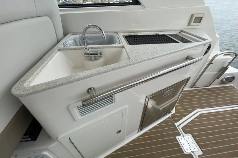 Motivated Yacht Photos Pics 2017 Regal 35 Sport Coupe yacht kitchenette with sink and grill on deck.