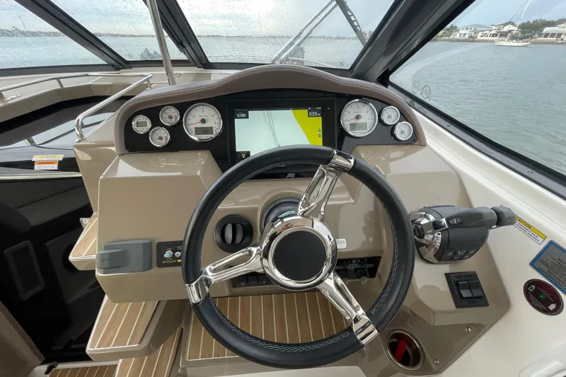 Motivated Yacht Photos Pics Steering console of 2017 Regal 35 Sport Coupe with modern controls and navigation display.