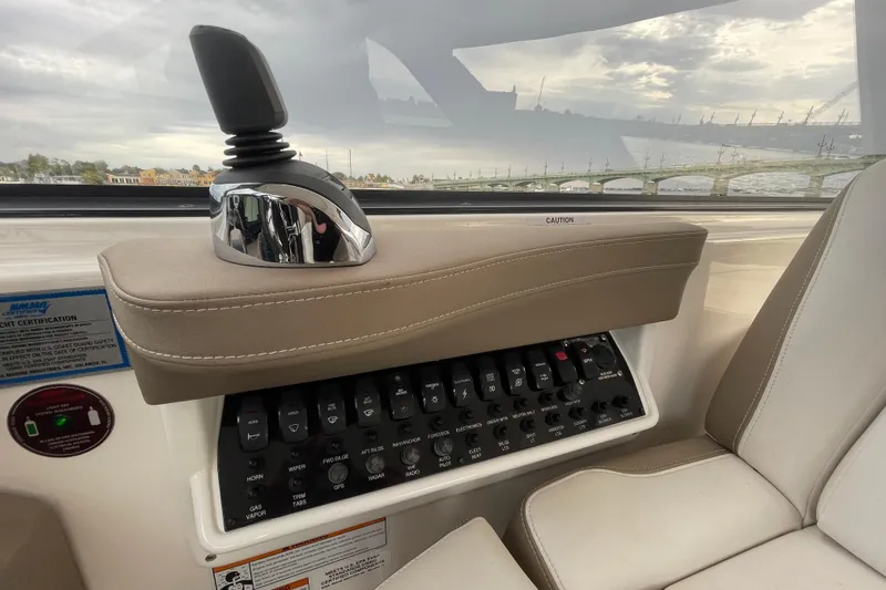Motivated Yacht Photos Pics 2017 Regal 35 Sport Coupe control panel with joystick and switches, interior view.