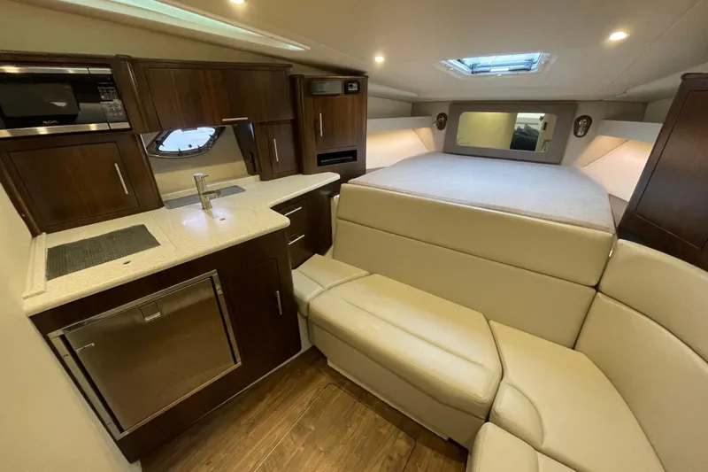 Motivated Yacht Photos Pics Luxurious interior of 2017 Regal 35 Sport Coupe with kitchenette and cozy seating area.