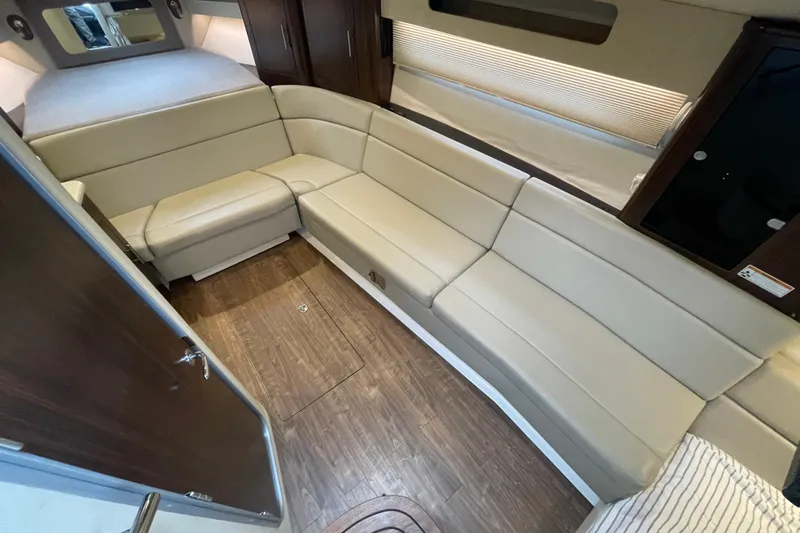 Motivated Yacht Photos Pics Interior of 2017 Regal 35 Sport Coupe with beige seating and wood flooring.