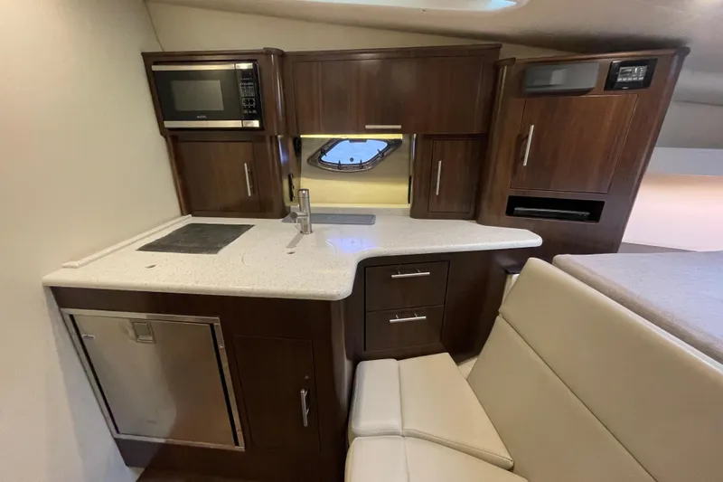 Motivated Yacht Photos Pics 2017 Regal 35 Sport Coupe interior kitchen with modern appliances and sleek cabinetry.