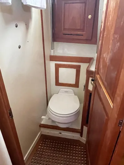 Full Sail Yacht Photos Pics 2003 Tartan 4600 yacht bathroom with wooden cabinetry and compact toilet.