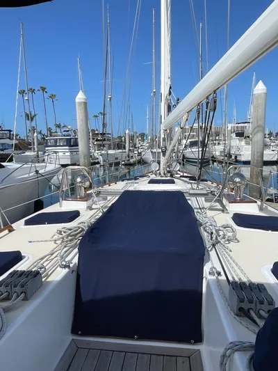 Full Sail Yacht Photos Pics 2003 Tartan 4600 sailboat docked in a marina with clear blue skies.