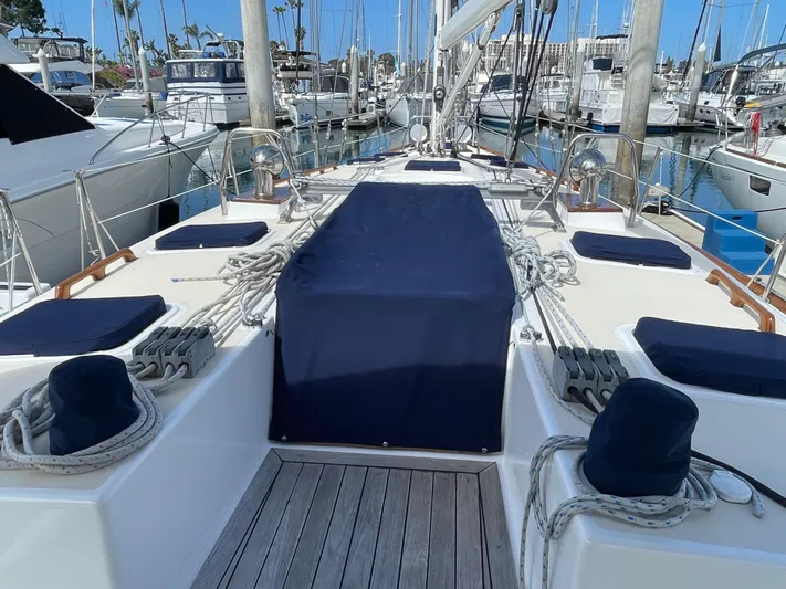 Full Sail Yacht Photos Pics Sailboat deck of 2003 Tartan 4600 in marina, featuring ropes and blue covers.