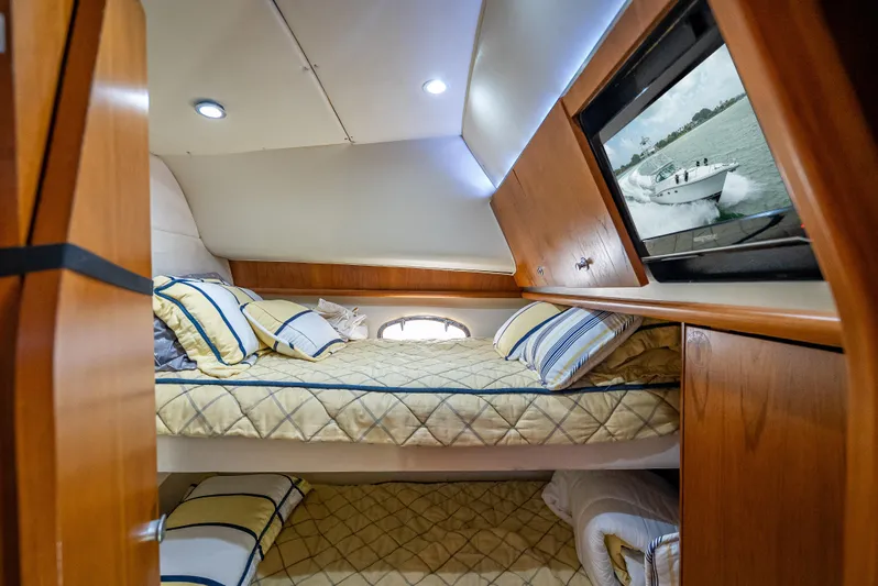 Drill Time Yacht Photos Pics 2006 Tiara Yachts 4200 Open cabin with cozy bedding and wooden interior.