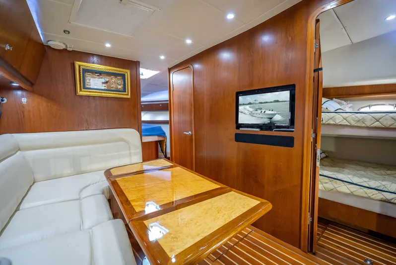 Drill Time Yacht Photos Pics Luxurious interior of 2006 Tiara Yachts 4200 Open, featuring wood paneling and cozy seating.