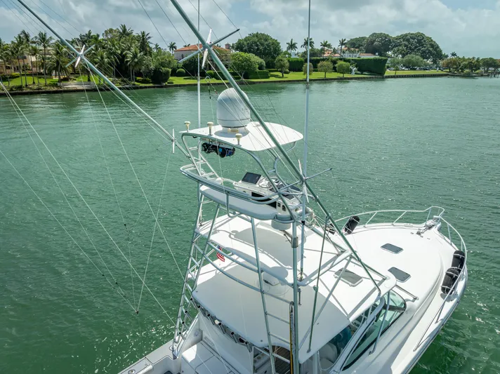 Drill Time Yacht Photos Pics 2006 Tiara Yachts 4200 Open on serene water with lush green shoreline.