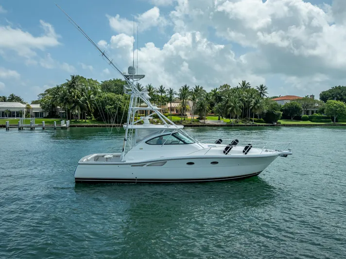 Drill Time Yacht Photos Pics 2006 Tiara Yachts 4200 Open cruising on a serene waterway with lush greenery.