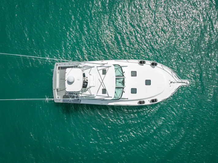 Drill Time Yacht Photos Pics Aerial view of 2006 Tiara Yachts 4200 Open on turquoise water.