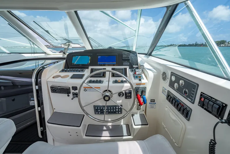 Drill Time Yacht Photos Pics Helm of 2006 Tiara Yachts 4200 Open, featuring modern navigation controls and steering wheel.