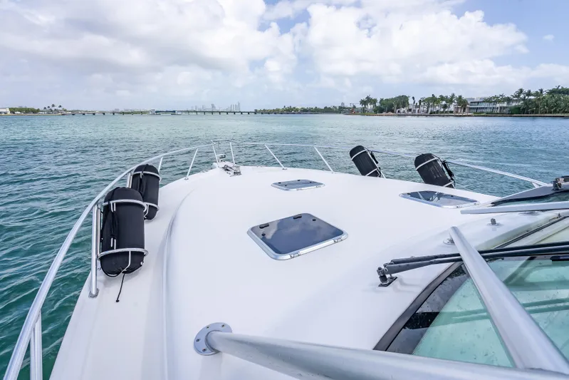 Drill Time Yacht Photos Pics 2006 Tiara Yachts 4200 Open cruising on calm waters under a cloudy sky.