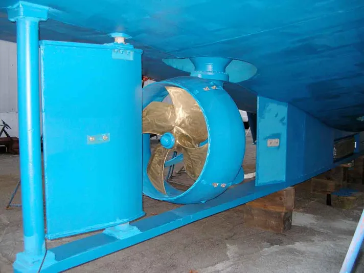 Evening Star Yacht Photos Pics 2003 Cape Horn Trawler propeller and hull, painted blue, in a dry dock setting.
