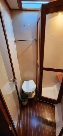  Yacht Photos Pics Bathroom interior of 1995 Mikelson 60 Sportfisher yacht with wooden flooring.