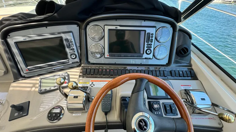  Yacht Photos Pics 2007 Sea Ray 44 Sundancer helm with dual navigation screens and wooden steering wheel.