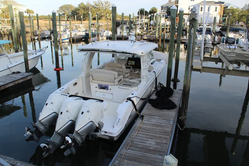 Get Off Me Yacht Photos Pics Boston Whaler 350 Realm 2021 docked with triple outboard engines.
