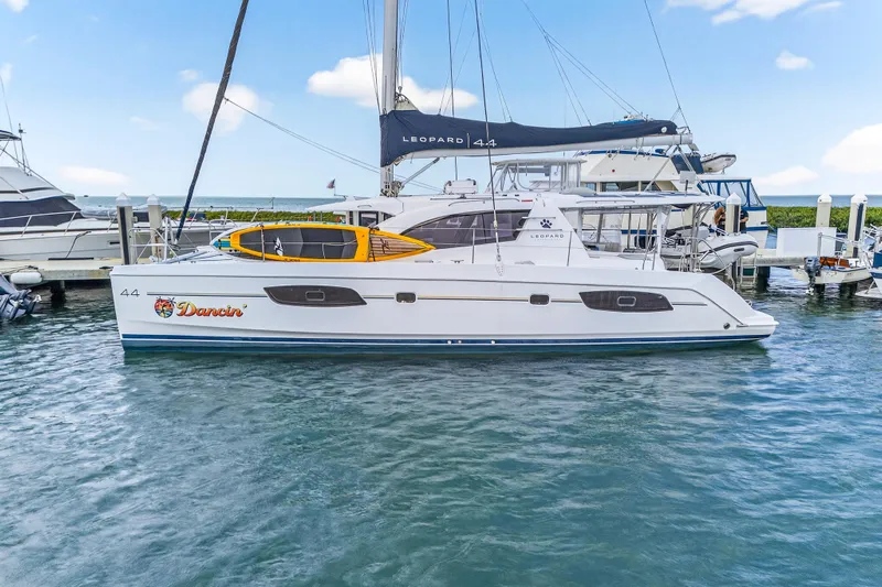  Yacht Photos Pics 2016 Leopard 44 Owners Version catamaran docked in a marina, side view.