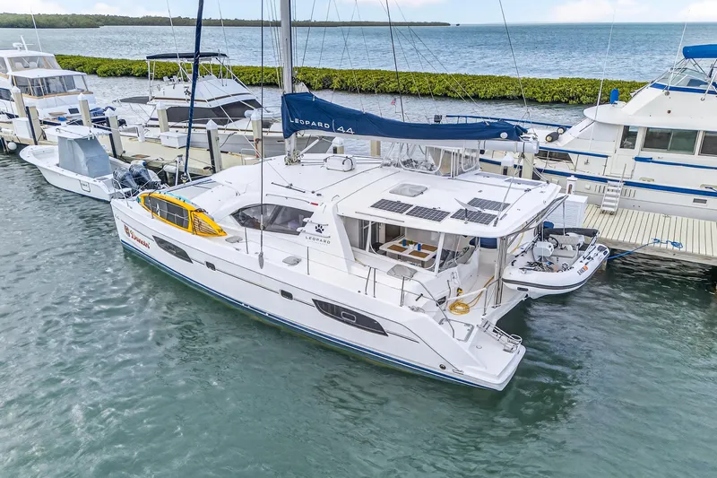  Yacht Photos Pics 2016 Leopard 44 Owners Version catamaran docked at marina, featuring solar panels and spacious deck.