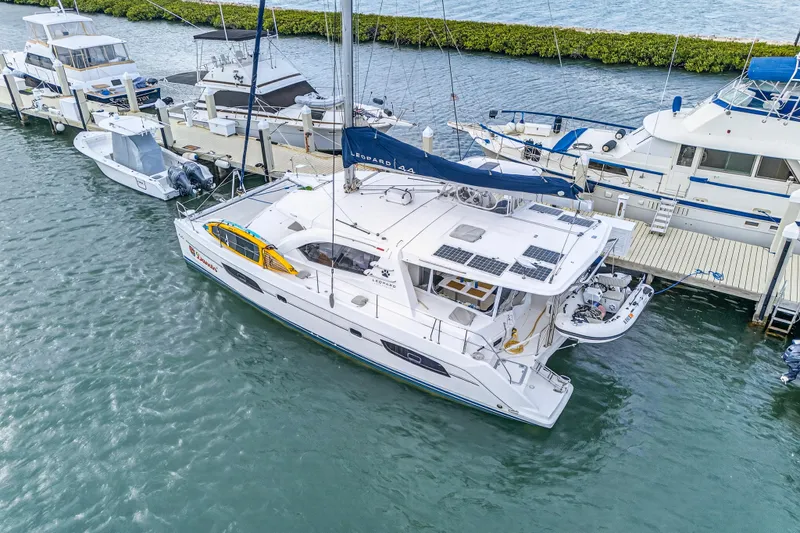  Yacht Photos Pics 2016 Leopard 44 Owners Version catamaran docked alongside other boats in a marina.