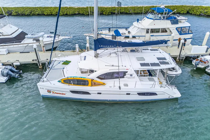  Yacht Photos Pics 2016 Leopard 44 Owners Version catamaran docked at marina, featuring solar panels and spacious deck.