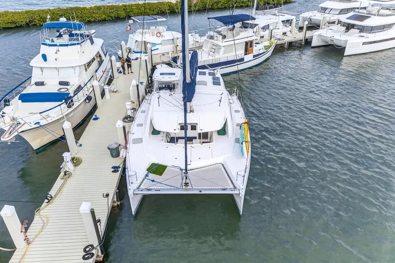 Yacht Photos Pics 2016 Leopard 44 Owners Version catamaran docked among other boats at a marina.