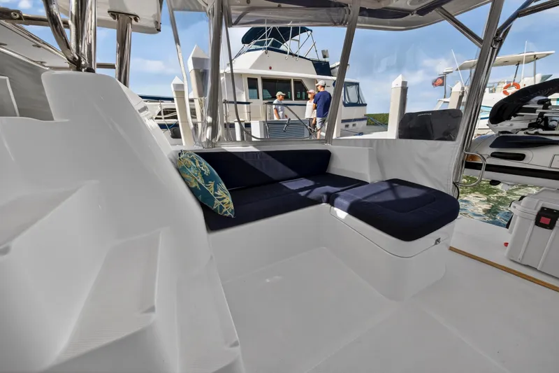  Yacht Photos Pics 2016 Leopard 44 Owners Version yacht interior with cushioned seating and marina view.