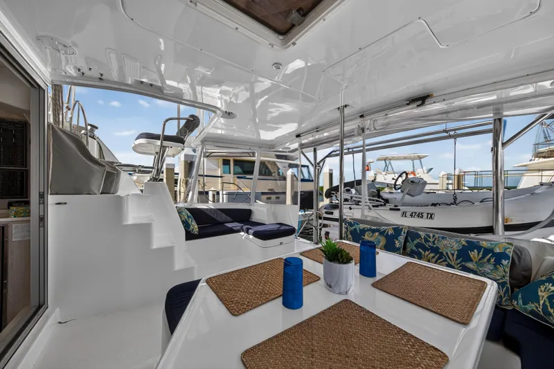  Yacht Photos Pics 2016 Leopard 44 Owners Version yacht interior with dining area and marina view.