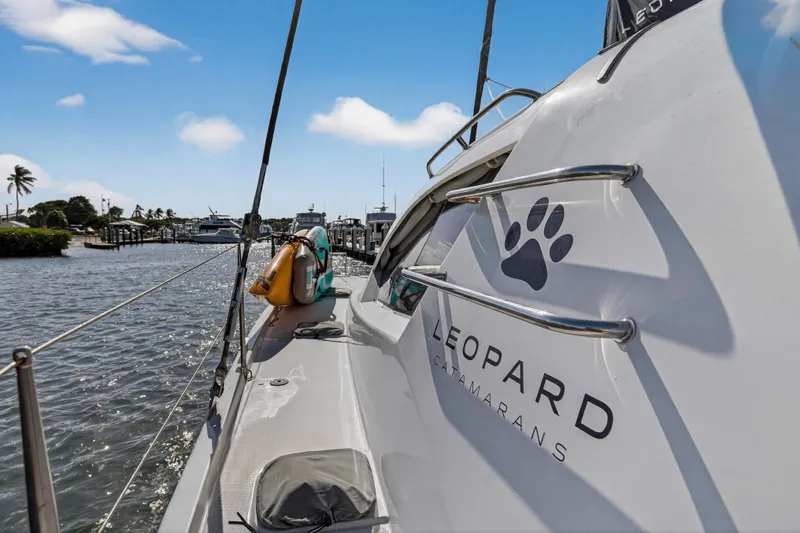  Yacht Photos Pics 2016 Leopard 44 Owners Version catamaran docked, showcasing sleek design and branding.