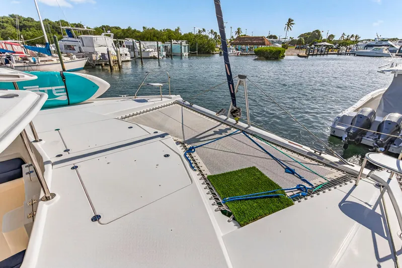  Yacht Photos Pics 2016 Leopard 44 Owners Version catamaran docked at marina, featuring spacious deck and netting.