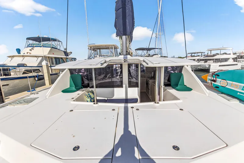  Yacht Photos Pics 2016 Leopard 44 Owners Version catamaran docked at marina, featuring spacious deck and seating.