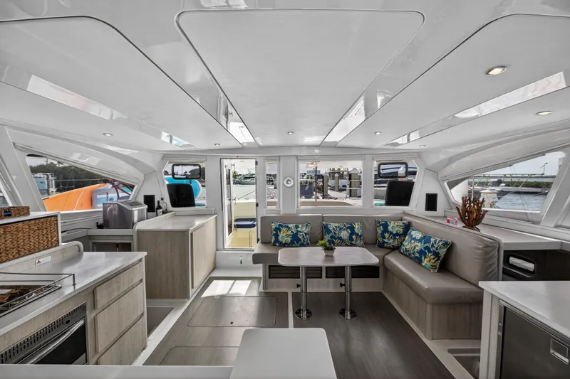  Yacht Photos Pics Spacious interior of 2016 Leopard 44 Owners Version catamaran with modern furnishings and large windows.